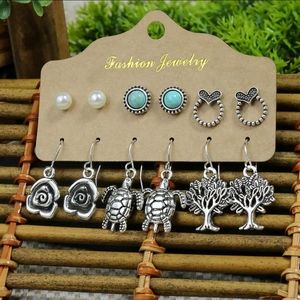 Earrings.  Silver plated zinc alloy.  Turtle, rose, tree, etc. Synthetic gems.